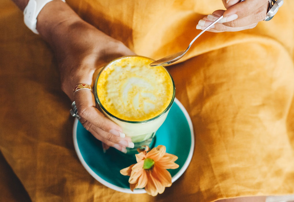 Woman with hot Turmeric Latte